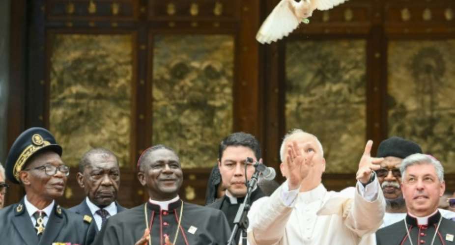 Pope Leo XIV releases a white dove after calling for peace in Cameroon.  By Alberto PIZZOLI (AFP)