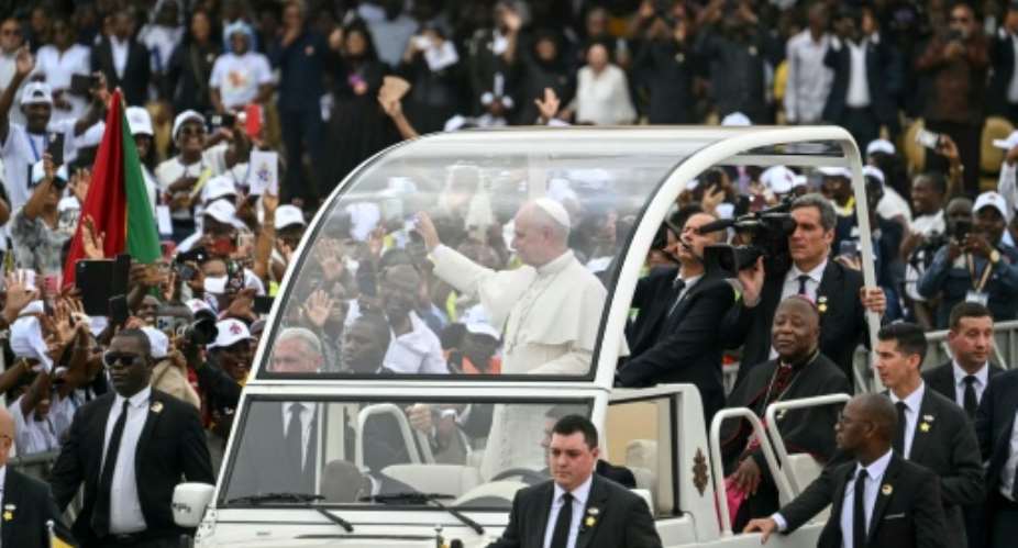 Pope Leo XIV travelled to his mass outside the Angolan capital on his popemobile.  By Alberto PIZZOLI (AFP)