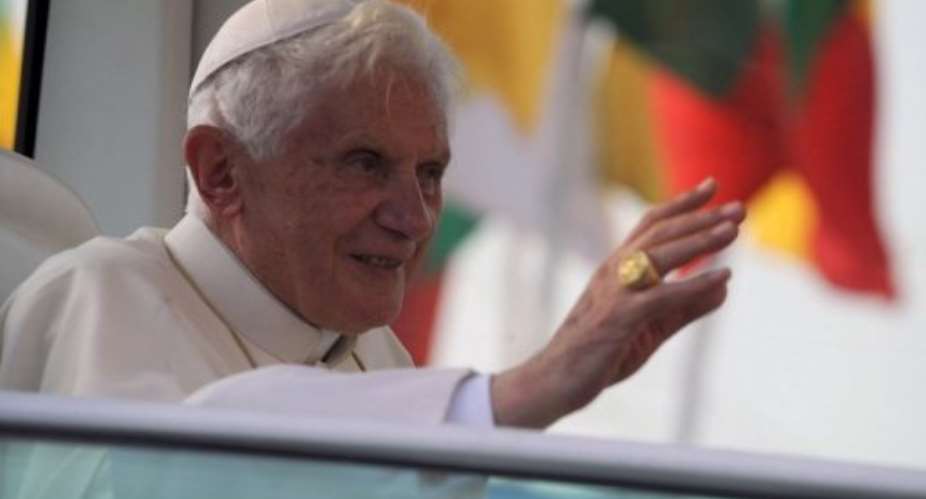 Pope Benedict XVI waves to the crowd in Cotonou.  By Pius Utomi Ekpei AFP
