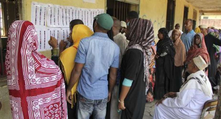 People queue outside a polling station in Mbeni, 50km northeast of the capital Moroni, Comoros, during the parliamentary election on January 25, 2015.  By Ibrahim Youssouf AFPFile
