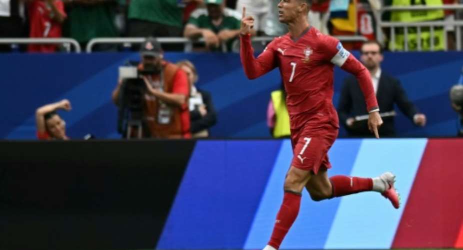 Portugal forward Cristiano Ronaldo celebrates after scoring his teams first goal in a 5-0 victory over Uzbekistan.  By Paul ELLIS (AFP)