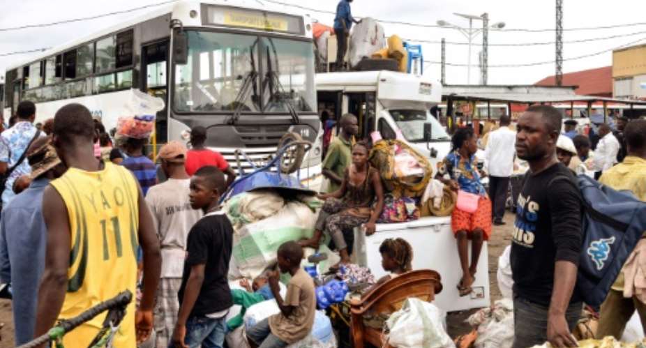 People from the Democratic Republic of Congo wait to board government-run buses in Ngobila beach as they arrive with their belongings from neighboring Congo Brazzaville after being forcefully deported, April 29, 2014.  By Junior D. Kannah AFPFile