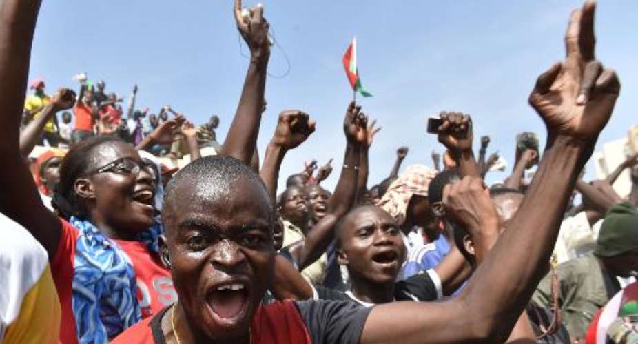People celebrate in Ouagadougou on October 31, 2014 after Burkina Faso's embattled President Blaise Compaore announced he was stepping down to make way for elections.  By Issouf Sanogo AFP