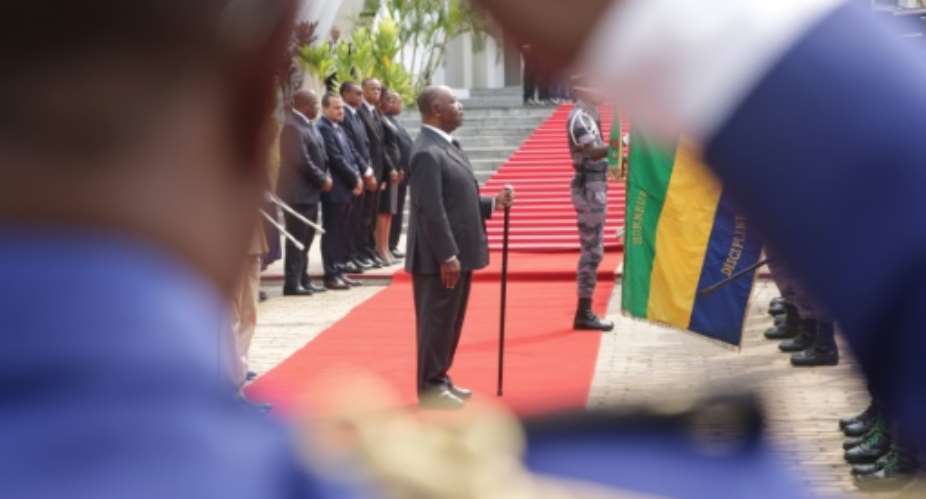President Ali Bongo, pictured here at a wreath-laying ceremony in August, has been in power for 10 years, succeeding his father Omar. Speculation about his health has swirled since he suffered a stroke in October 2018.  By STEVE JORDAN AFP