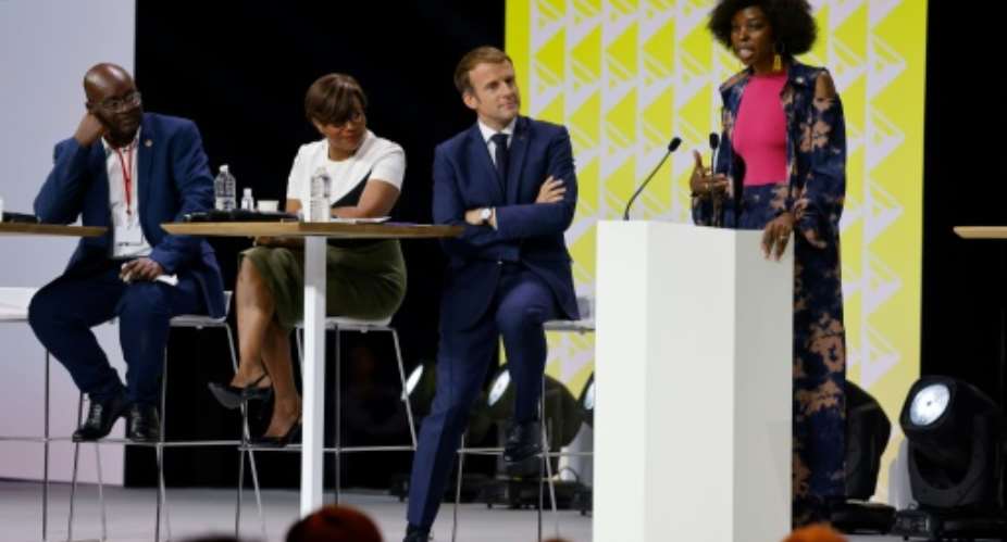 President Emmanuel Macron listened as Adelle Onyango of Kenya assailed France's 'denial' of its colonial past.  By Ludovic MARIN AFP