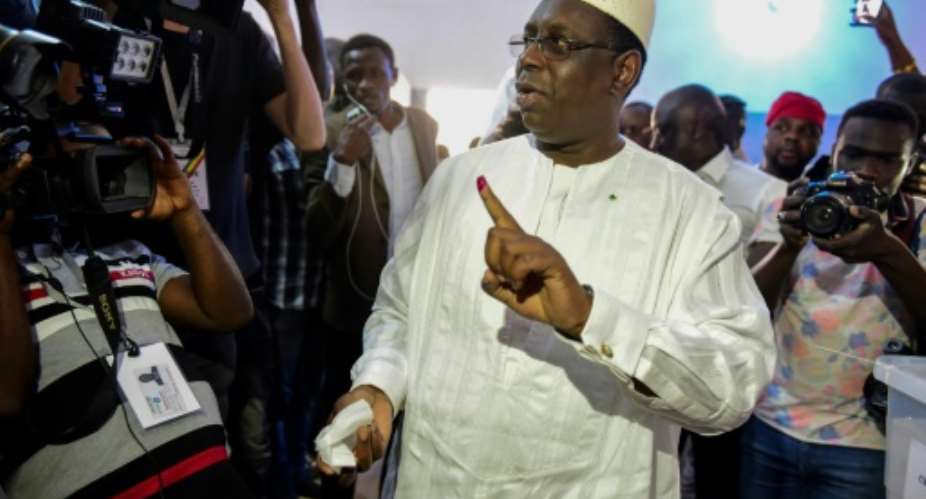 President Macky Sall has won a second term with 57 of the vote, according to the prime minister.  By SEYLLOU AFP