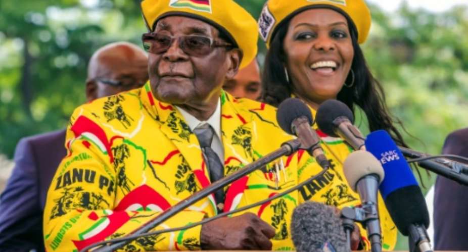 President Mugabe and his wife Grace addressed party members after the vice president, Emmerson Mnangagwa, was sacked -- a move that was followed by the military's warning on Monday.  By Jekesai NJIKIZANA AFP