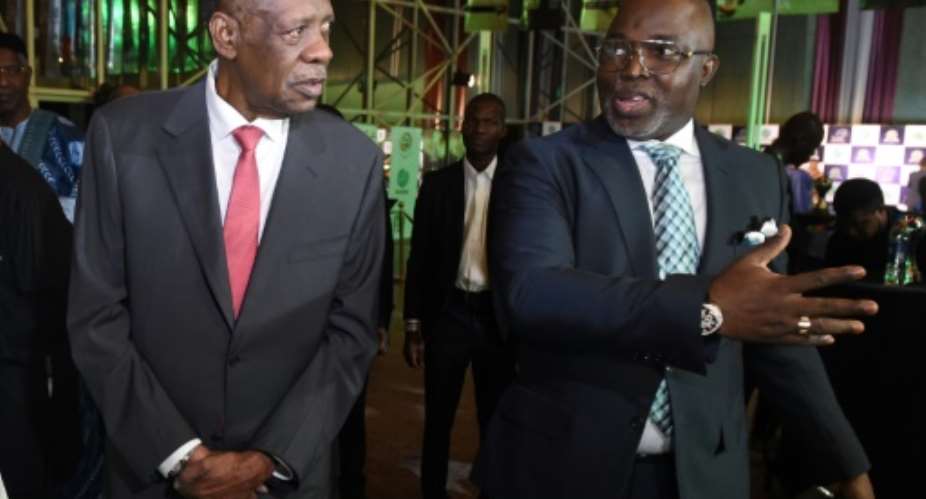 President of the Nigerian Football Federation Amaju Pinnick R speaks with incumbent president of the Confederation of African Football Issa Hayatou in January 2017.  By PIUS UTOMI EKPEI AFPFile