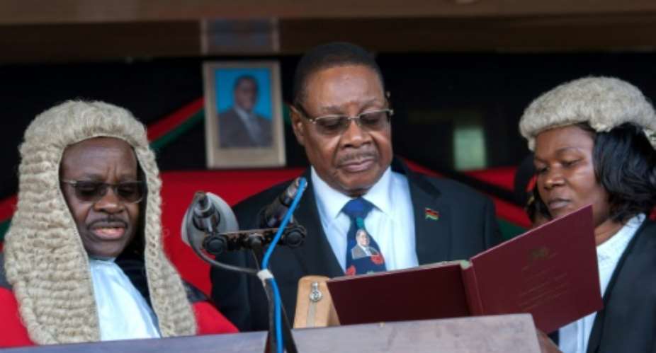 President Peter Mutharika shown being sworn in May 28, 2019 by Chief Justice Andrew Nyirenda, L is appealing after the Constitutional Court annulled the election and ordered a re-run, citing 'grave' and 'widespread' irregularities.  By AMOS GUMULIRA AFPFile