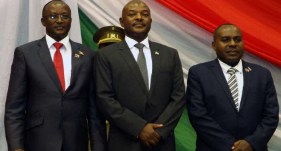 President Pierre Nkurunziza poses with his new first and second vice-presidents in August 2015 after being sworn in for a controversial third term in power.  By LANDRY NSHIMIYE AFPFile