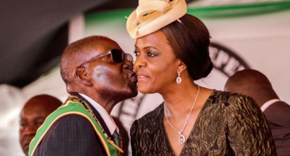 President Robert Mugabe kisses his wife and first lady Grace Mugabe during the country's 37th Independence Day celebrations in April.  By Jekesai NJIKIZANA AFPFile