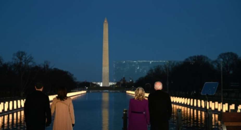 President-elect Joe Biden R and incoming First Lady Jill Biden watch as a Covid-19 memorial is lit in Washington, DC.  By Jim WATSON AFP