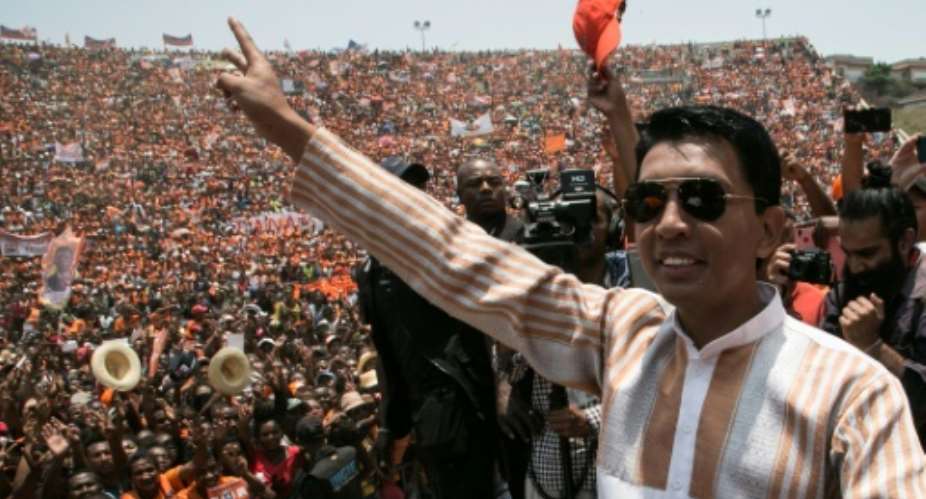 Presidential candidate and former President of the High Transitional Authority of Madagascar Andry Rajoelina waves to supporters as he arrives on stage during a campaign rally at the Colyseum stadium in Antananarivo, on November 3, 2018.  By RIJASOLO AFPFile