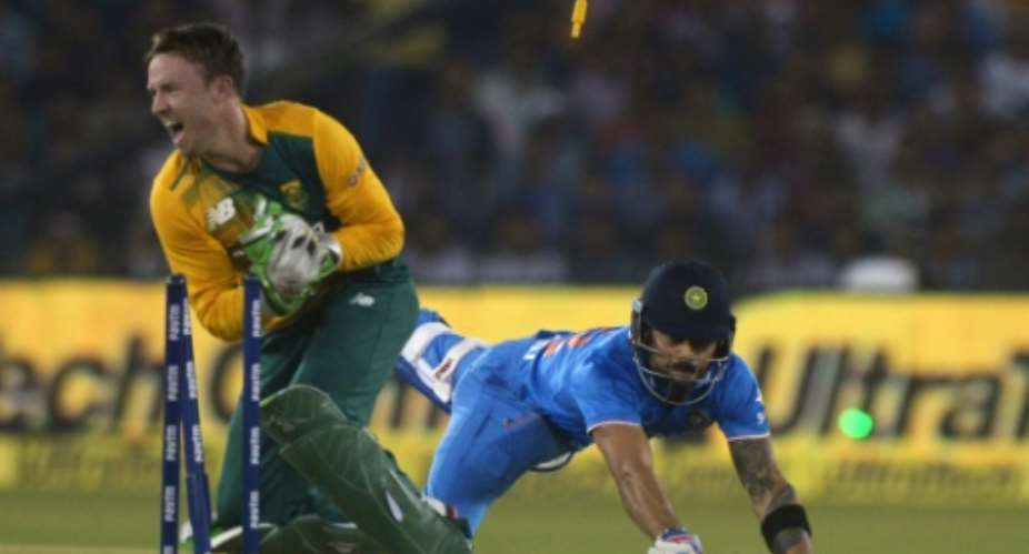 India's Virat Kohli R dives to reach the crease as South Africa's AB de Villiers runs him out during their T20 match at The Barabati Stadium in Cuttack, on October 5, 2015.  By Dibyangshu Sarkar AFPFile