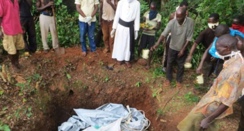 Priest Jean-Alain Zembi, seen overseeing the burial of six people, has given a vivid account on social media of violence in Zemio, southeast Central African Republic.  By Jean-Alain ZEMBI HandoutAFP