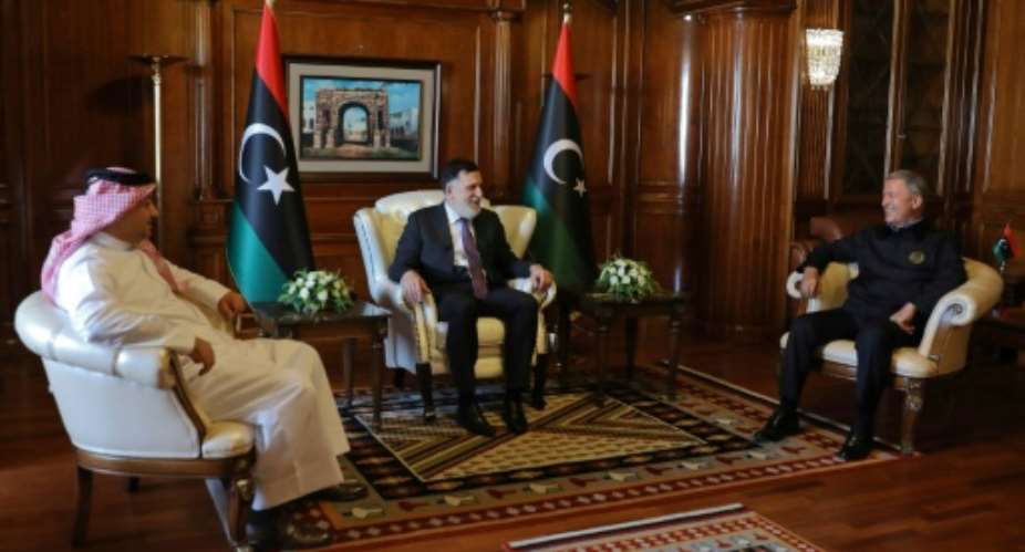 Prime Minister of Libya's UN-recognised Government of National Accord GNA Fayez al-Sarraj C meets with Turkish Defence Minister Hulusi Akar R, and his Qatari conterpart Khaled bin Mohammad Al-Attiyah L in the capital Tripoli.  By - AFP