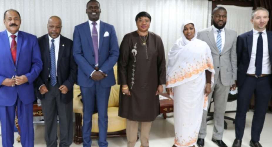 Prosecutor of the International Criminal Court, Fatou Bensouda C, poses with Sudanese officials, including Justice Minister Nasruddin Abdel Bari 3rd L, during her visit to Khartoum.  By - AFP