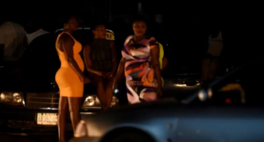 Prostitutes stand on the street in Benin City, Nigeria's capital for illegal migration. International Organization for Migration has recorded an explosion in the number of Nigerian women trafficked into Europe.  By PIUS UTOMI EKPEI AFP
