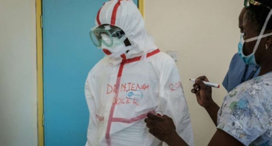 Protection: A doctor gets suited up for visiting a quarantine ward at Kenyatta National Hospital in Nairobi.  By Yasuyoshi CHIBA AFP