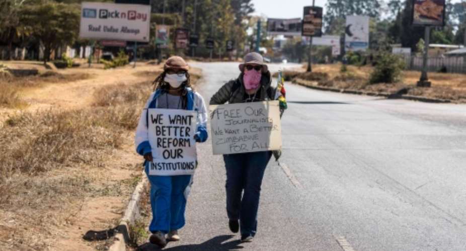 Protest: Zimbabwean novelist Tsitsi Dangarembga, left, and friend Julie Barnes, shortly before their arrest.  By ZINYANGE AUNTONY AFP