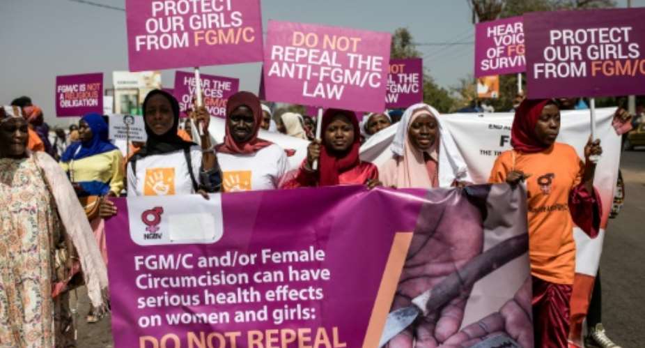 Protesters against female genital mutilation rally outside The Gambias National Assembly.  By MUHAMADOU BITTAYE (AFP/File)
