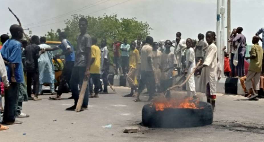 Protesters block a main road in the northern Nigerian city of Maiduguri, demanding the authorities ban a local anti-Boko Haram militia they say is abusing them.  By Audu MARTE AFP