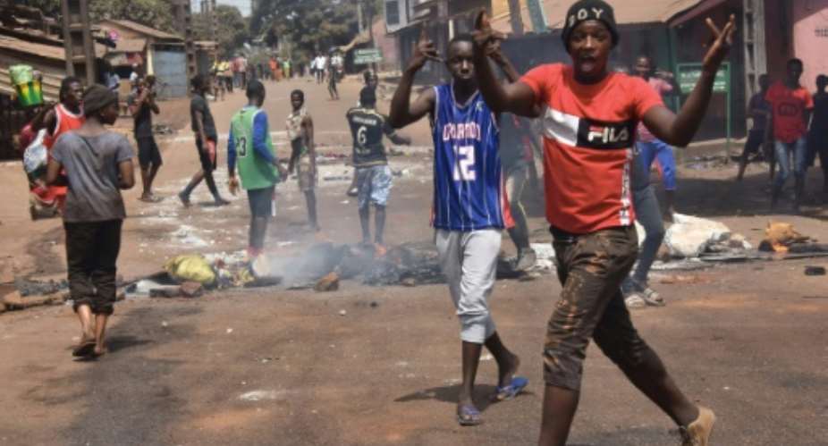 Protesters burn rubbish and block roads along the axis of democracy as demonstrations broke out in Conakry in February 2020 after Guinea's President Alpha Conde postponed a parliamentary election.  By CELLOU BINANI AFPFile