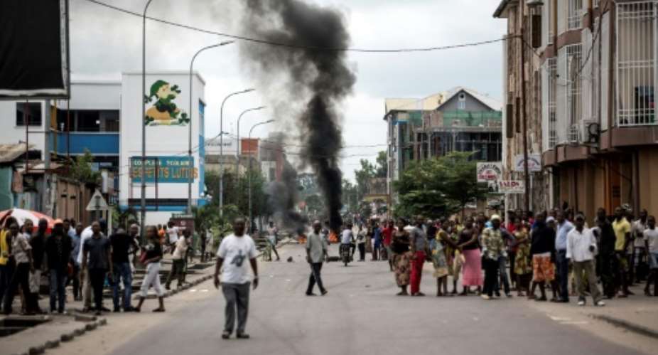 Protesters burn tyres during a demonstration calling for Joseph Kabila to step down.  By JOHN WESSELS AFPFile