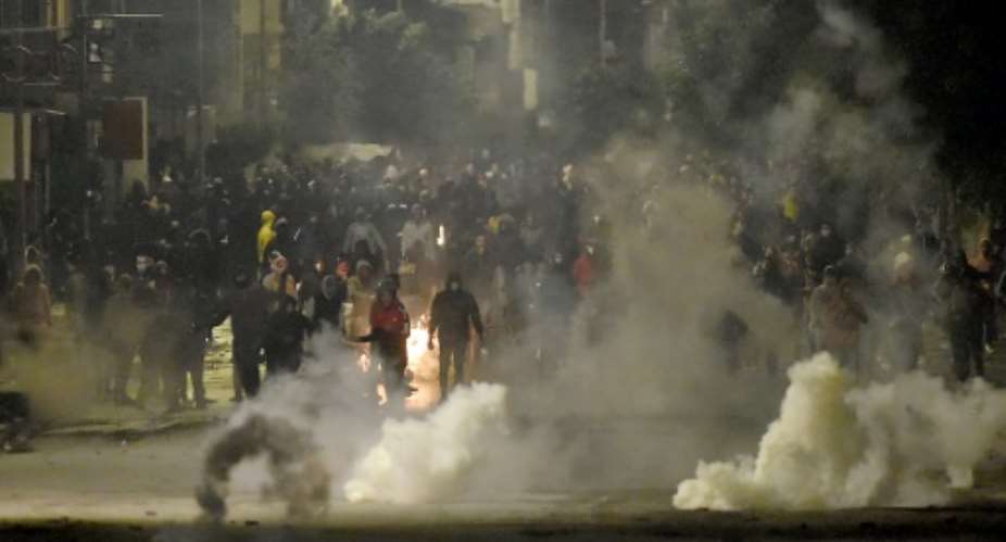 Protesters clash with security forces in the Ettadhamen  suburb of Tunis on Monday night.  By FETHI BELAID AFP