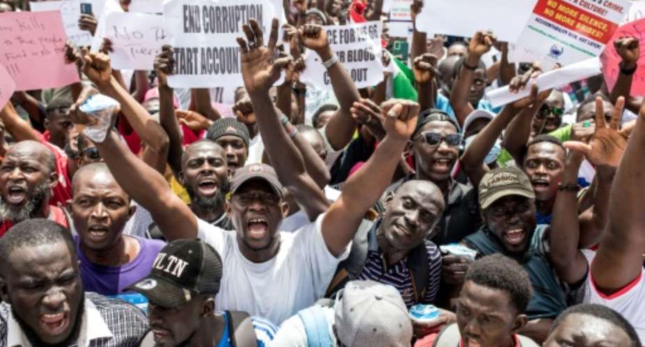 Protesters demand accountability from government leaders at a demonstration in Banjul on July 23, 2025.  By MUHAMADOU BITTAYE (AFP)