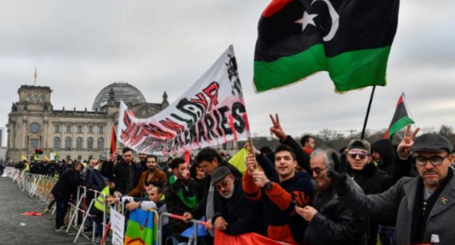 Protesters hold a banner reading Stop war in Libya, Haftar and mercenaries during a protest near the chancellery during the Peace summit on Libya at the Chancellery in Berlin on January 19, 2020.  By John MACDOUGALL AFPFile