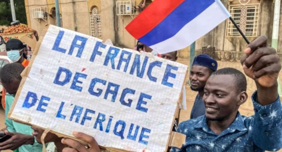 Protesters hold an anti-France placard during a protest in Niamey, the capital of Niger, in August 2023.  By - AFP