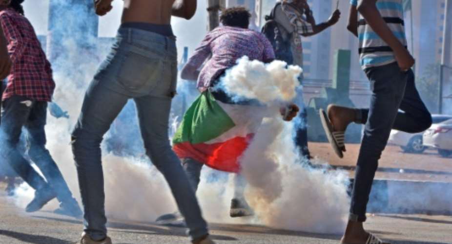 Protesters on Tuesday threw tear gas canisters back at security forces in Sudan's capital Khartoum.  By - AFP