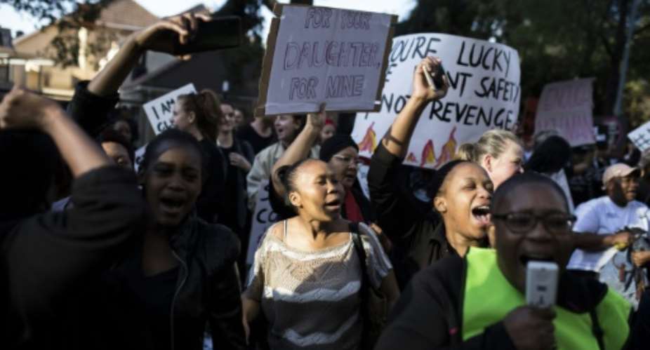 Protesters rallied outside Johannesburg Stock Exchange.  By GUILLEM SARTORIO AFP