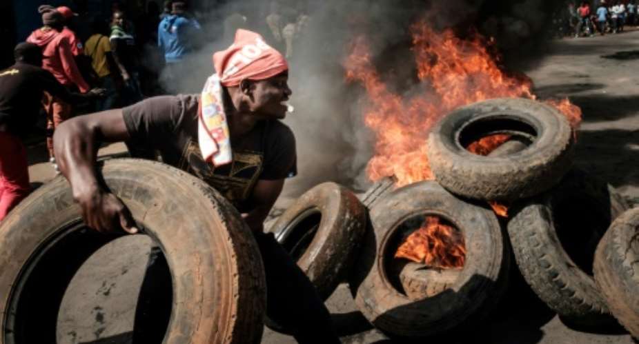 Protesters set fire to tyres in Kibera, an opposition bastion in the capital Nairobi.  By Yasuyoshi CHIBA AFP