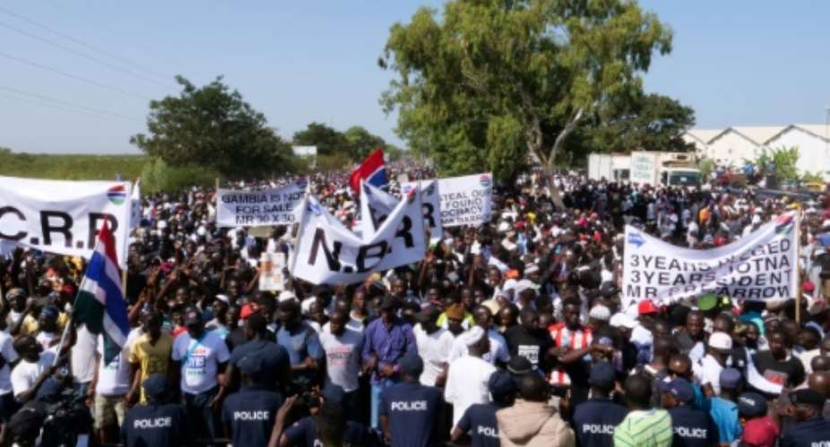 Protesters take part in a demonstration against Gambian President Adama Barrow, calling for him to keep his pledge to quit after three years in office.  By Romain CHANSON AFP