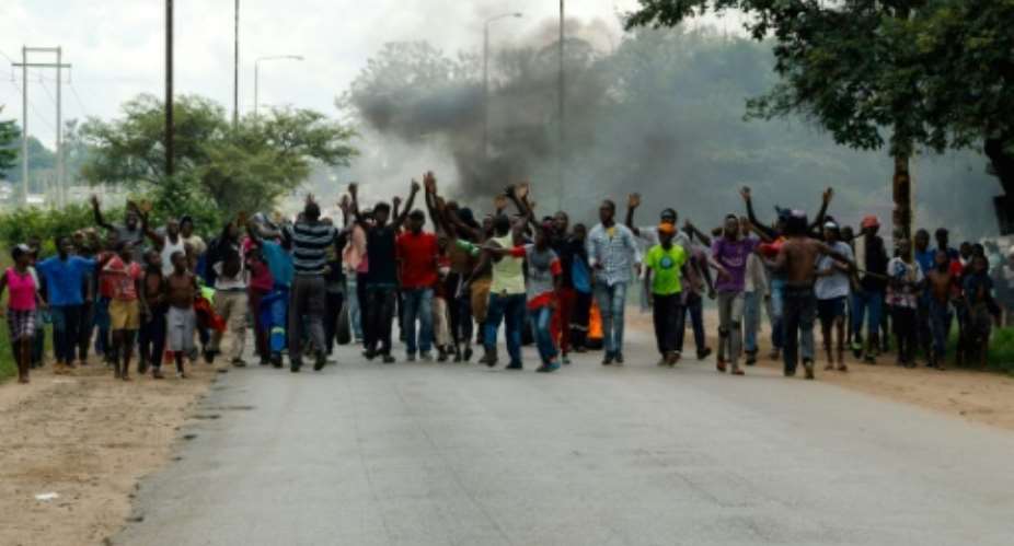Protestors blocked roads on January 14 after the government doubled the price of fuel.  By Jekesai NJIKIZANA AFP