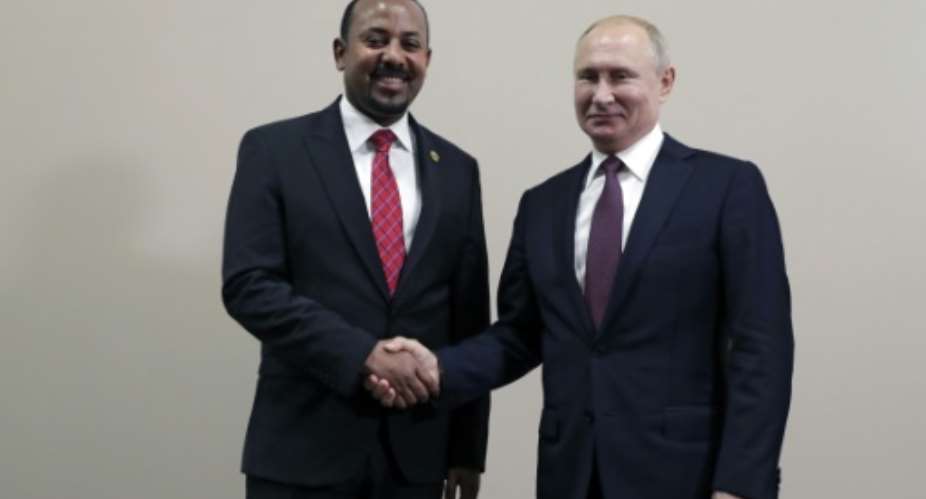 Protests against Abiy Ahmed, this year's Nobel Peace Prize laureate, erupted in Addis Ababa and in Ethiopia's Oromia region after an activist accused security forces of trying to orchestrate an attack against him; pictured October 23 2019 with Russian President Vladimir Putin.  By Mikhail METZEL SPUTNIKAFP
