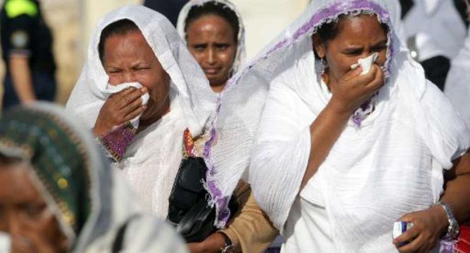 Women weep on October 21, 2013 in the southern Sicilian city of Agrigento during a ceremony commemorating the migrants who drowned off the southern Italian islad of Lampedusa.  By Marcello Paternostro (AFP)