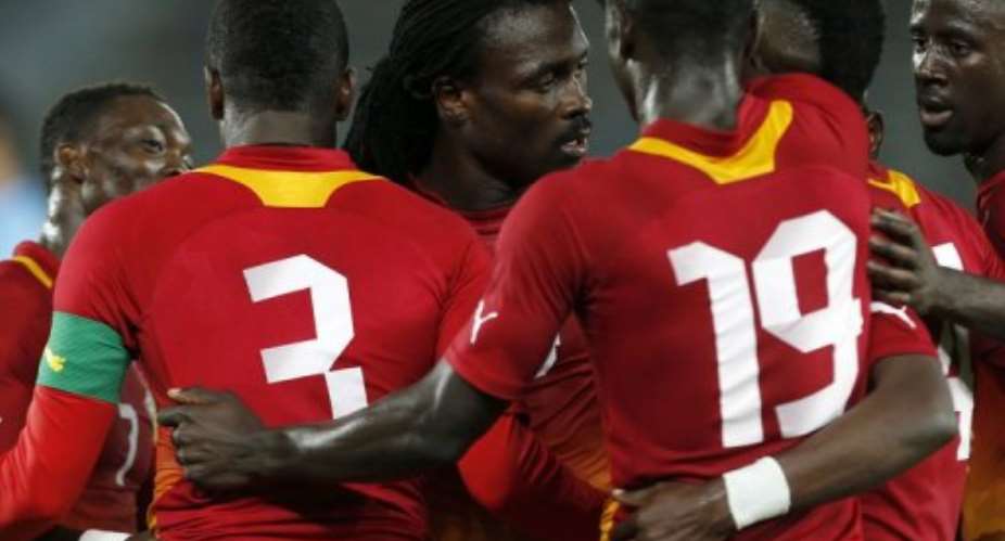 Ghanas John Pantsil (C) celebrates with his teammates after beating Tunisia in a football friendly on January 13, 2013.  By Karim Sahib (AFP/File)