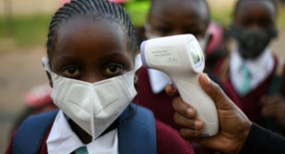 Pupils at Our Lady of Mercy primary school in Nairobi had their temperature taken before they returned to class.  By Simon MAINA AFP