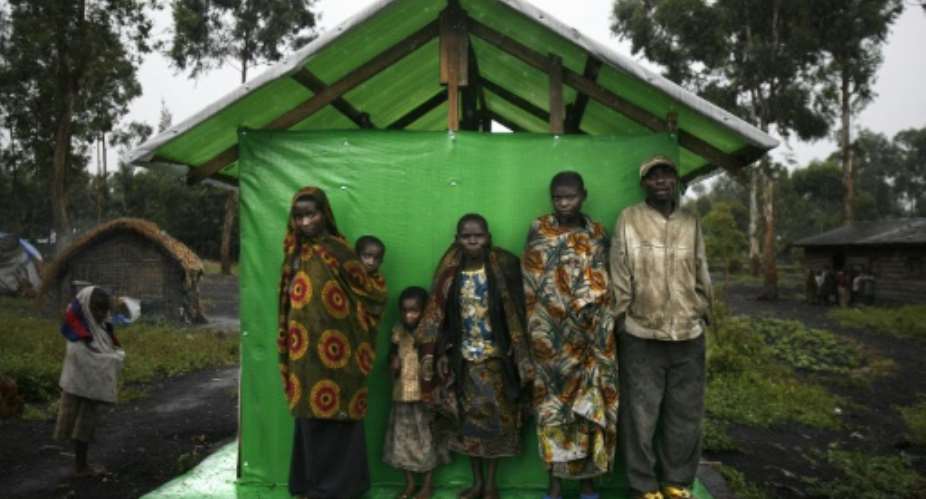 A picture taken on October 26, 2006 shows a group of pygmies sheltering from the rain in Mubambiro village, near Goma, Democratic Republic of Congo.  By Jose Cendon AFPFile