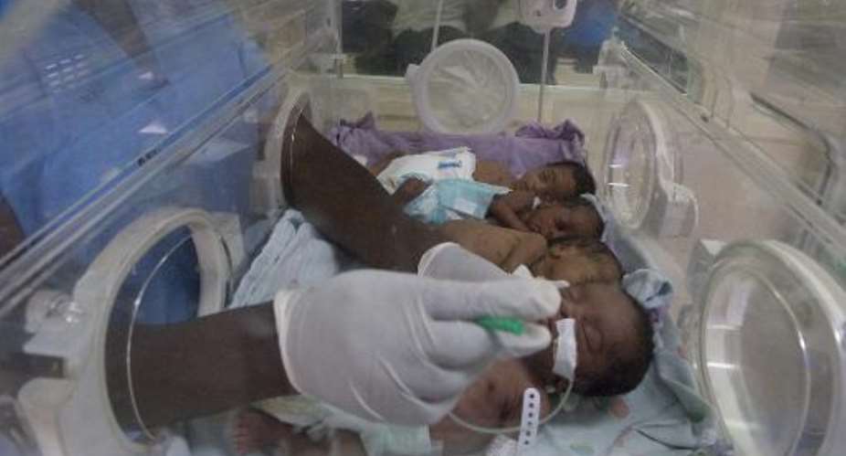 A nurse attends to four newly born babies on December 19, 2013 at a hospital in Nairobi.  By Simon Maina (AFP/File)