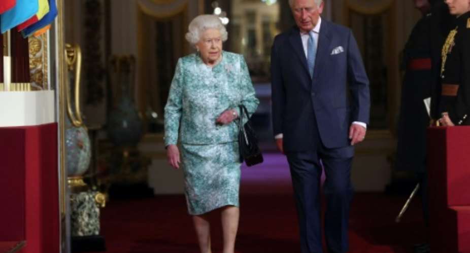 Queen Elizabeth II and Prince Charles arrive for the formal opening of the Commonwealth Heads of Government Meeting in Buckingham Palace..  By Jonathan Brady POOLAFP