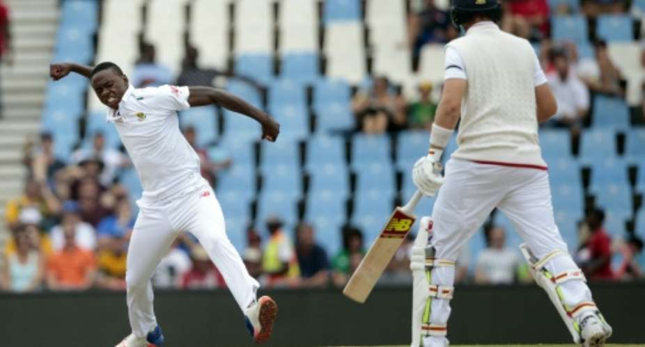 South Africa fast bowler Kagiso Rabada L celebrates the dismissal of England's batsman Joe Root R on day three of the fourth Test at the SuperSport Park in Centurion on January 24, 2016.  By Gianluigi Guercia AFP