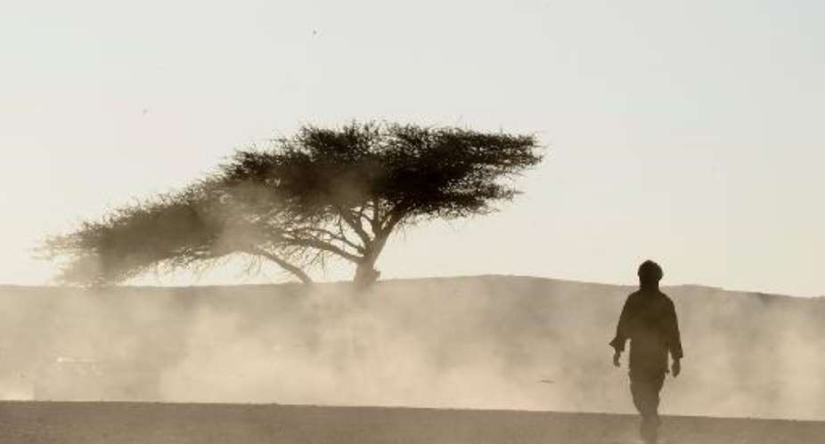 Sahrawi men walk in the desert on February 27, 2011 in the Western Sahara village of Tifariti.  By Dominique Faget (AFP/File)