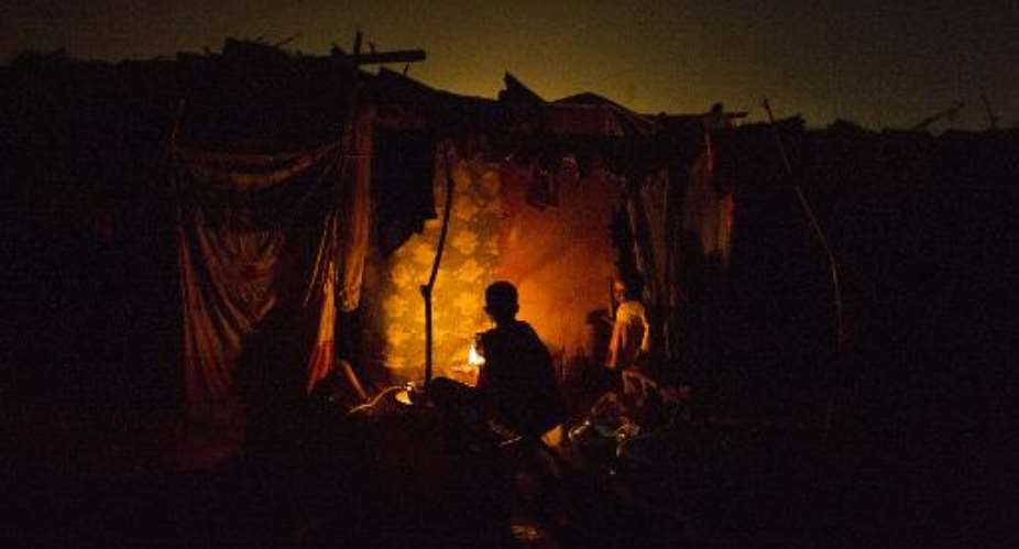 A woman cooks in a tent in the refugee camp at M'Poko airport, in Bangui, Central African Republic, on February 22, 2014.  By Fred Dufour AFPFile