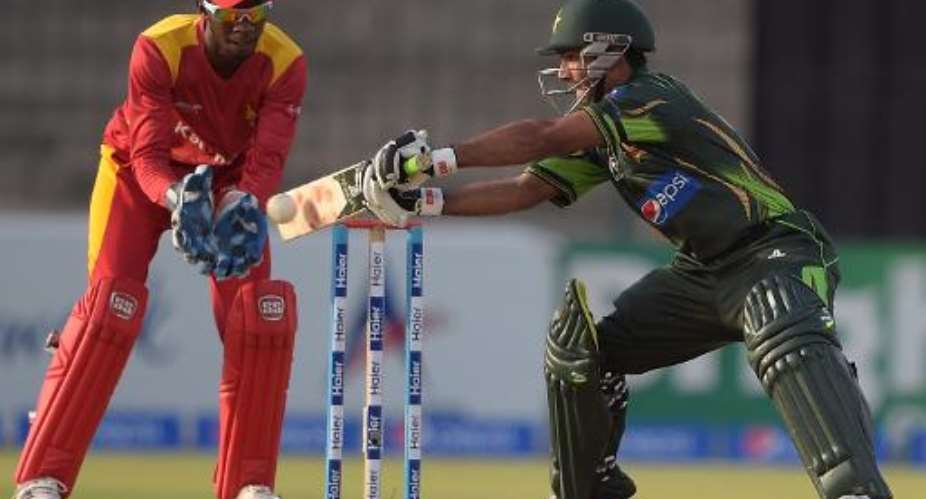 Pakistan's Asad Shafiq R plays a shot as Zimbabwe's wicketkeeper Richmond Mutumbami looks on during the third and final one day international match at the Gaddafi Cricket Stadium in Lahore on May 31, 2015.  By Aamir Qureshi AFP