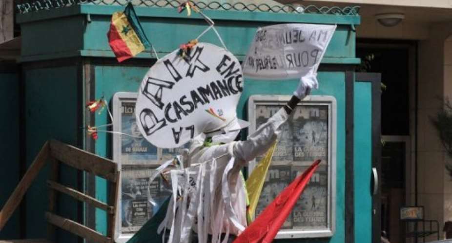 A lonely demonstrator stands with placards asking for peace in Casamance.  By Issouf Sanogo (AFP/File)