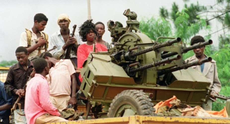Rebels loyal to warlord Charles Taylor patrol Monrovia's streets in August 1990 during Liberia's first civil war.  By PASCAL GUYOT AFP